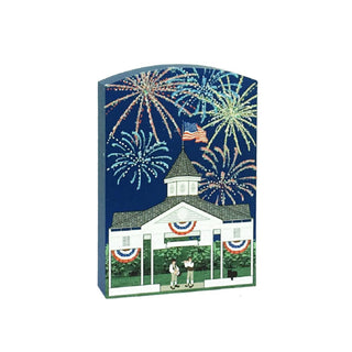 3/4" Wooden replica with an illustration with a building, American flag, and fireworks on a blue background