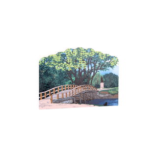 3/4" wooden replica with an illustration of a Wooden bridge over a body of water with trees in the background on a white background