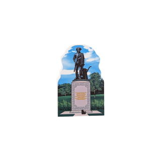 3/4" wooden replica with an illustration of a statue with a dog in a park setting