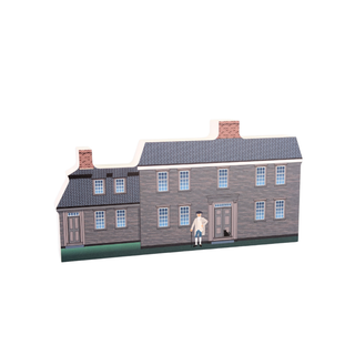 3/4" wooden replica with an illustration  of a house with a person standing in front on a white background