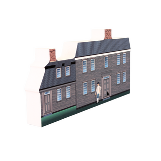 3/4" wooden replica with an illustration of a two-story house with a person standing in front on a white background