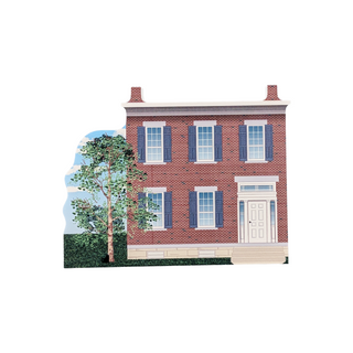 3/4" wooden replica with an illustration of a two-story brick house with blue shutters on a white background