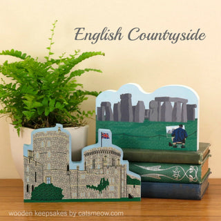 Wooden keepsakes depicting Stonehenge, Windsor Castle, and a person with a dog on a bench, labeled 'English Countryside'.