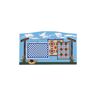 3/4" thick wooden illustration of a clothesline of quilts