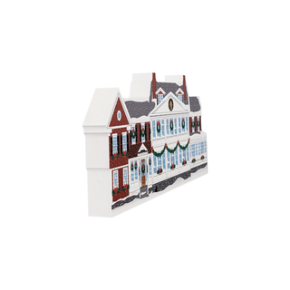 3/4" thick wooden illustration of a building with Christmas decor on a white background