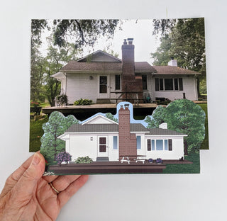 Hand holding a 3D house model with a real house in the background