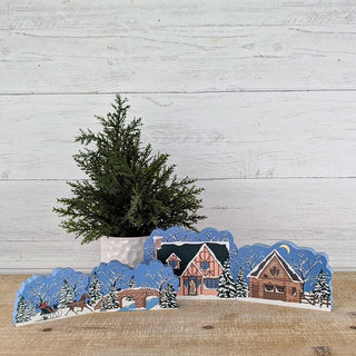 3/4" thick wooden illustrations of a winter scene on display