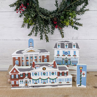 3/4" thick wooden illustrations of a Christmas town on display