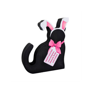 hand holding a wooden replica black cat that has a pink bow and bunny ears on a white background with a tag that you can add your own words too 