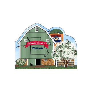 3/4" thick wooden Decorative sign of a green barn with 'Celebrate America Missouri' text, surrounded by flowers and trees.