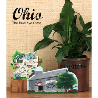 Decorative Ohio-shaped 3/4" thick wooden cutout with a barn design, potted plant, and 'Ohio' text on a wooden surface.
