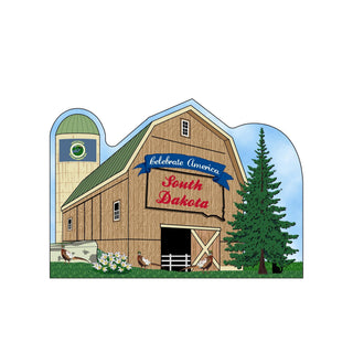 3/4" thick wooden cutout  of a barn with 'Celebrate America South Dakota' text, silo, and trees.