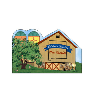 3/4" thick wooden cutout  of a barn with 'Celebrate America New Mexico' banner, silos, and trees.