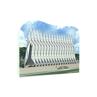 3/4" thick wooden model of Modern architectural design with pointed roof and geometric pattern against a blue sky.