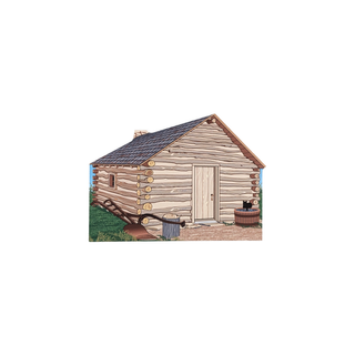 3/4" thick wooden figurine  of a log cabin with a door and windows on a white background