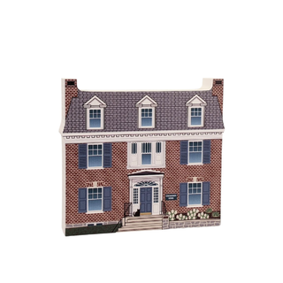 3/4" thick wooden cutout of a brick house with blue shutters on a white background