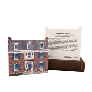 3/4" thick wooden cutout of a house with an attached card detailing 'Eisenhower House' at Gettysburg College Admissions Building.