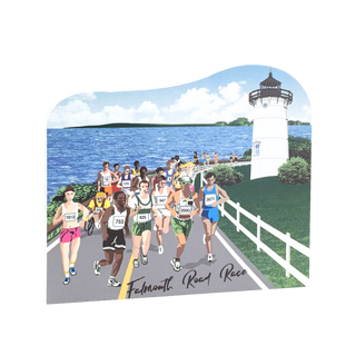 wooden replica with design of runners on a road with a lighthouse and ocean in the background for falmouth road race 