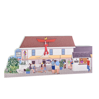 wooden replica of a quaint store with a large red lobster sign called mac's shack