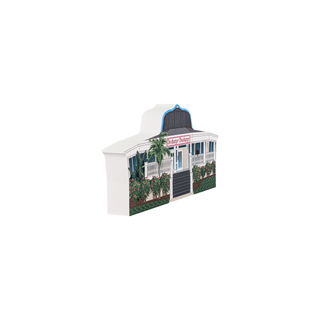 3/4" wooden replica with an illustration  of a small building with a sign on a white background
