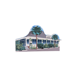 3/4" wooden replica with an illustration  of a house with palm trees on a white background