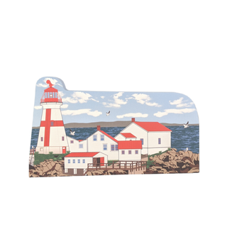 3/4" thick wooden cutout of  a lighthouse and buildings by the sea with birds flying.