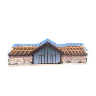 3/4" wooden replica with an illustration of a building with a stone facade and wooden roof on a white background