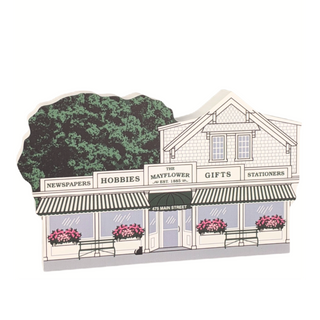 wooden replica of a quaint store front with various services and decorative elements called the mayflower