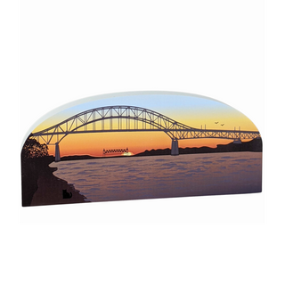 Wooden illustrated replica of a bridge over water during sunset.