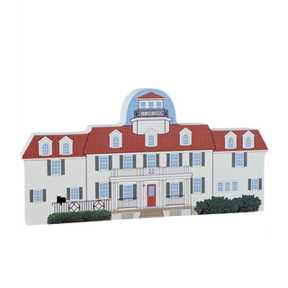 Wooden model of a house with a red roof and white walls on a white background