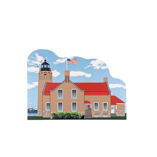 3/4" wooden replica with an illustration  of a lighthouse with a red roof and an American flag on a white background