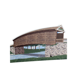 3/4" thick wooden cutout of  a covered bridge with stone walls and trees in the background