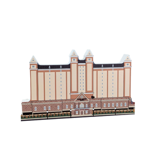 3/4" wooden replica with an illustration of a large building with a brick base and beige upper section on a white background