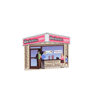 3/4" wooden replica with an illustration of a Wockenfuss Candies store front with people around it on a white background