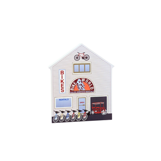 3/4" wooden replica with an illustration of a bike shop with various graphics on a white background