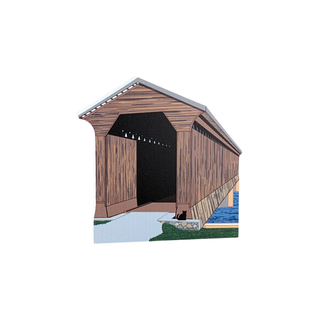 3/4" thick wooden covered bridge with a cat sitting on a rock by the water on a white background