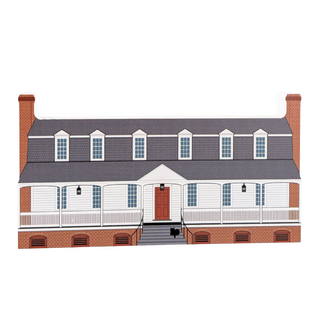 wooden replica with an Illustration of a two-story house with a gray roof and red brick exterior.