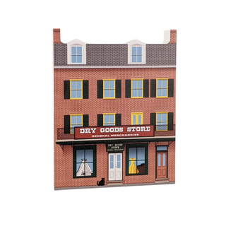 3/4" thick wooden illustration of a dry goods store with a red sign and windows displaying items.