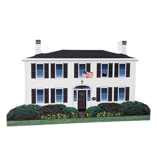Wooden replica of a two-story house with black shutters and an American flag on a white background