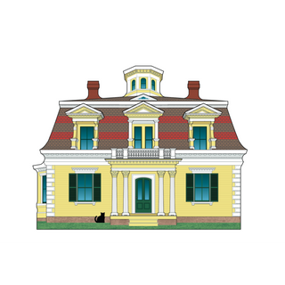 Wooden replica of a yellow house with green windows and a black cat on the lawn.