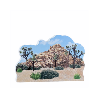3/4" thick wooden illustration of a desert landscape with rocky outcrop, Joshua trees, and shrubs on a white background