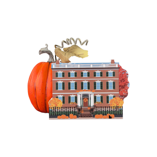Pumpkin with a 3/4" thick wooden miniature house design on a white background