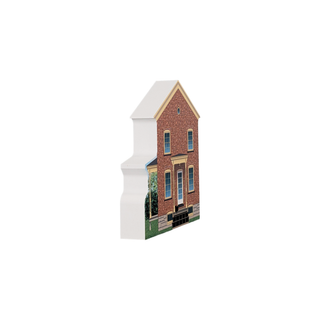 3/4" wooden replica with an illustration of a brick building with a white roof on a white background