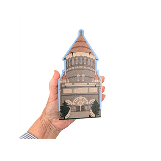 Hand holding a 3/4" thick wooden illustration of a monument