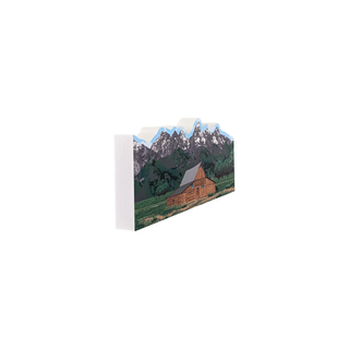 3/4" wooden replica with an illustration of a barn with scenic mountains in the background 