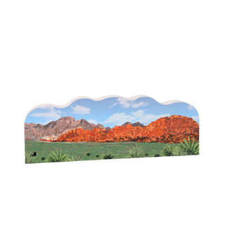 3/4" thick wooden Desert landscape with red rock formations and green grass on a white background
