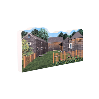 3/4" wooden replica with an illustration of a small village with houses and a fence on a white background