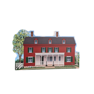 3/4" wooden replica with an illustration of a red brick house with white trim and a tree in the background