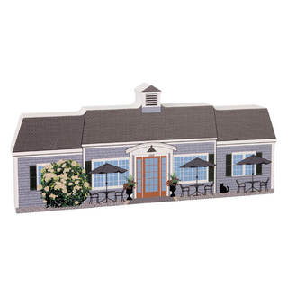 3/4" thick wooden Model of a building with outdoor seating area on a white background