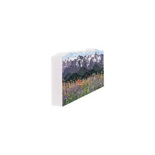 3/4" wooden cut out replica of an illustration of a Mountain landscape with snow-capped peaks and a field of colorful flowers.